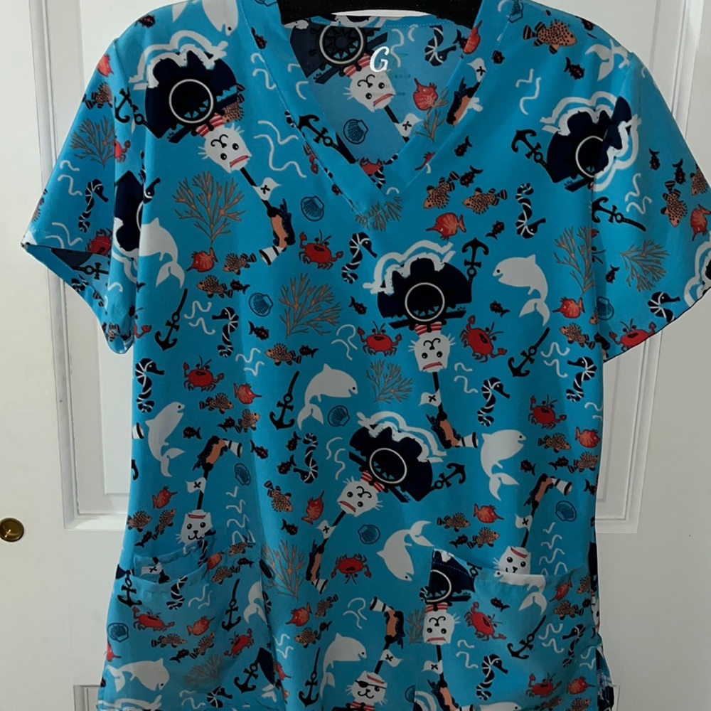 Medium fish sea cat pirate scrub top, super fun and cool lightly used very comfy